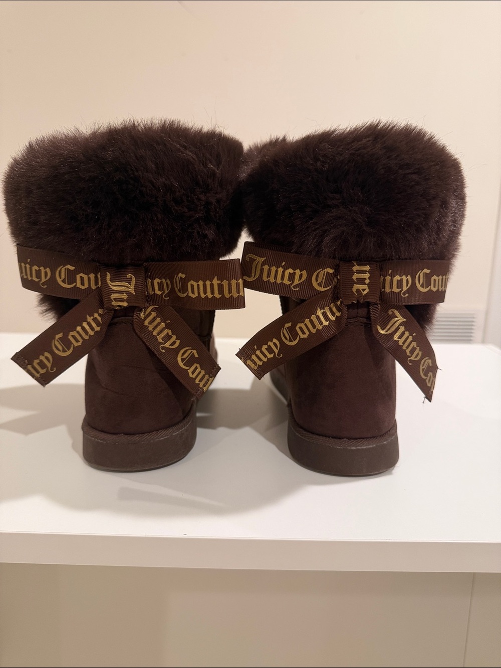 NWOT. Juicy Couture Dark Brown Faux Fur Bow Back Boots